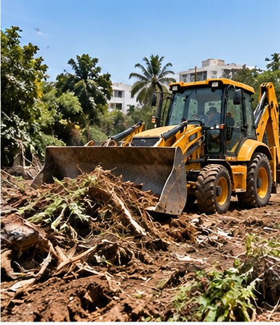 JCB clearing vegetation and debris from a construction site
